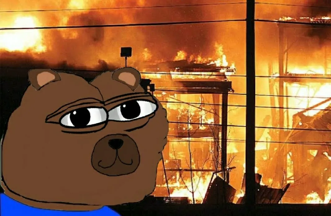Bobo smiling in front of a burning building